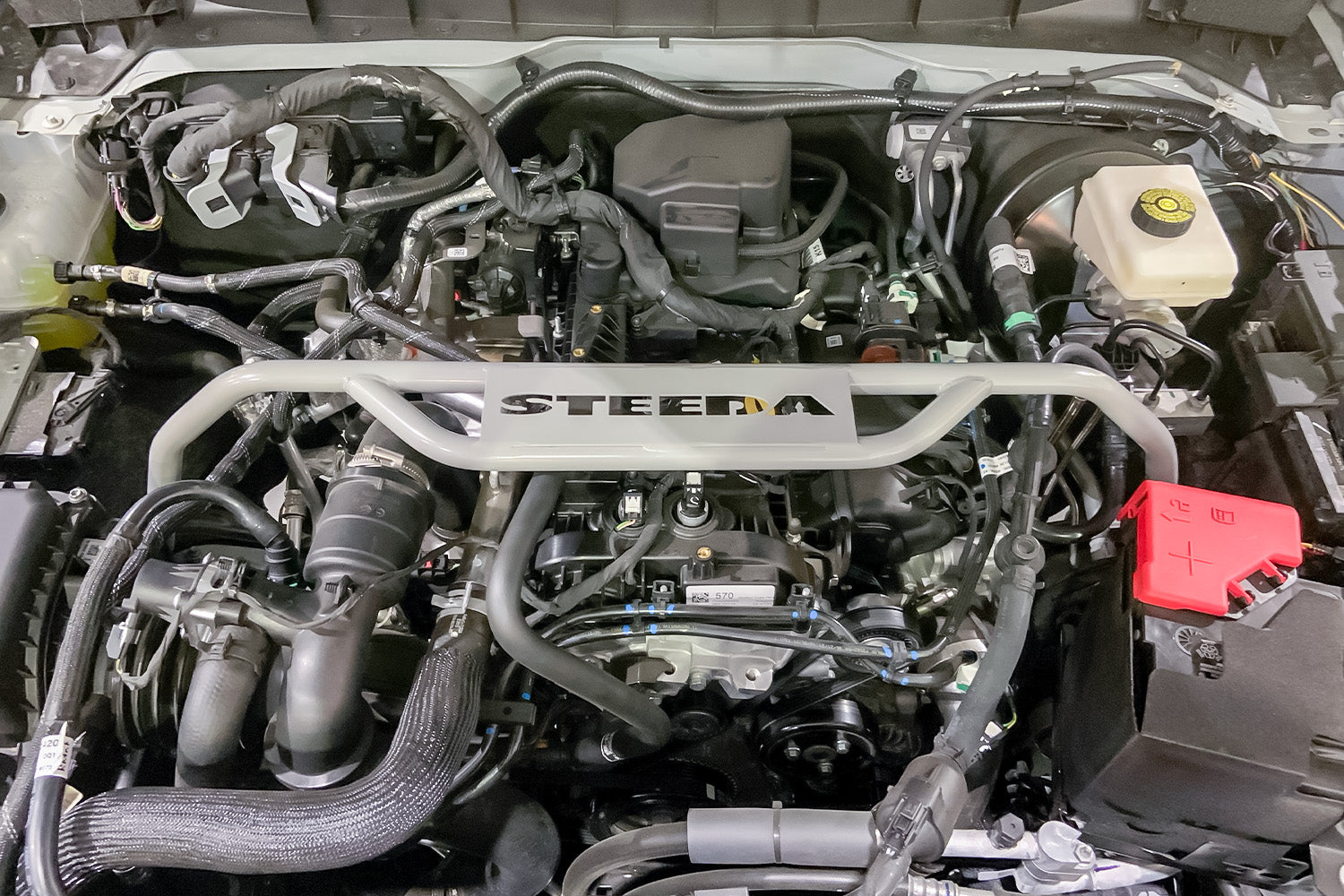 Steeda Strut Tower Brace for Ford Bronco 2021, 2022, 2023 installed in engine bay close up front on