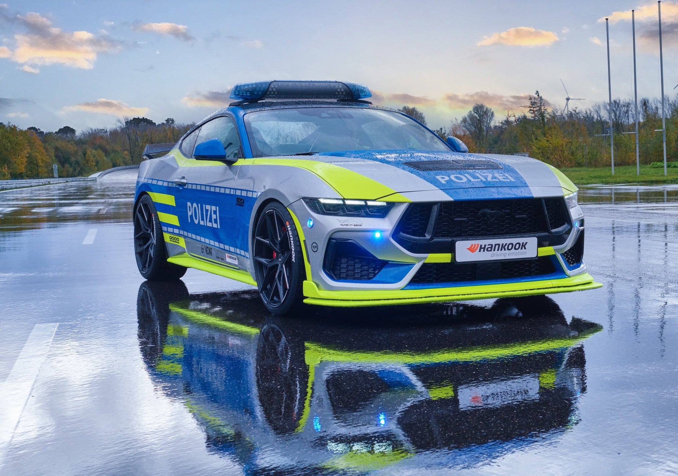 Steeda Q500 Police car on a wet road with a clear sky